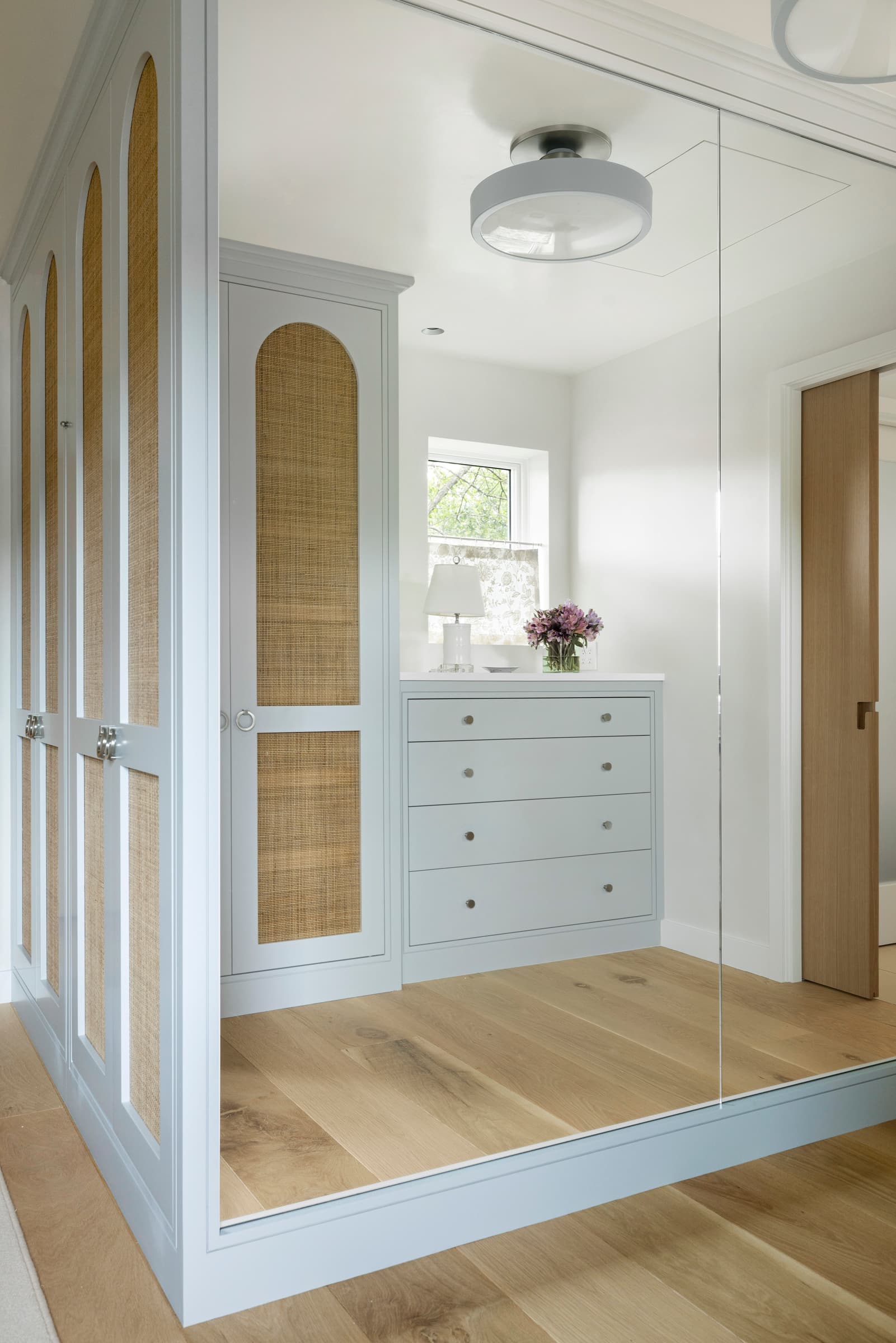 Luxury custom closet cabinetry and wardrobe systems: Cane Arched Closet Dresser 055